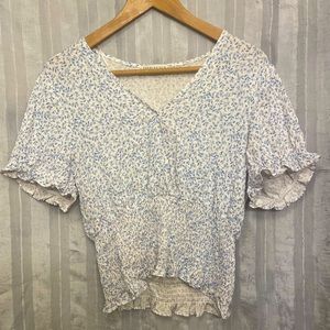 Paper Crane short sleeve blouse with blue floral pattern. Woman’s size Large.